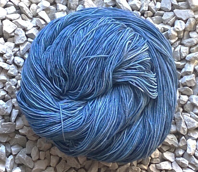 Photo of a skein of BFL/Nylon hand-dyed in 'Stormy Sky' rolled into a solid circle