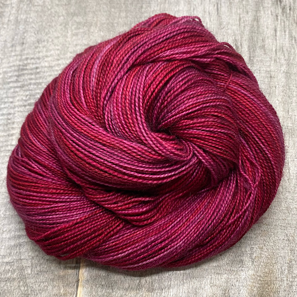 A swirl of hand dyed yarn in colour 'Claret'