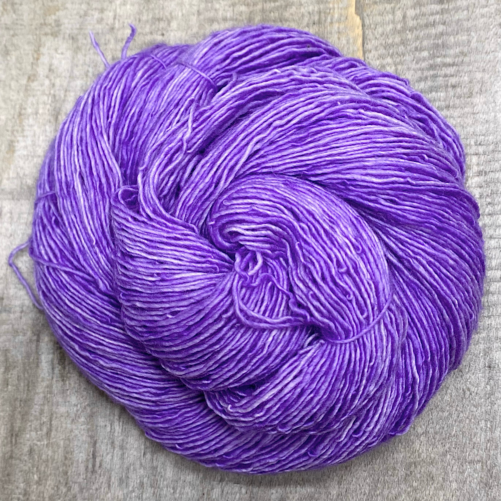 A swirl of hand-dyed skein of Pure Merino wool, single spun. The colour is 'Lilac Love', a colour inspired by my dark lilac tree.